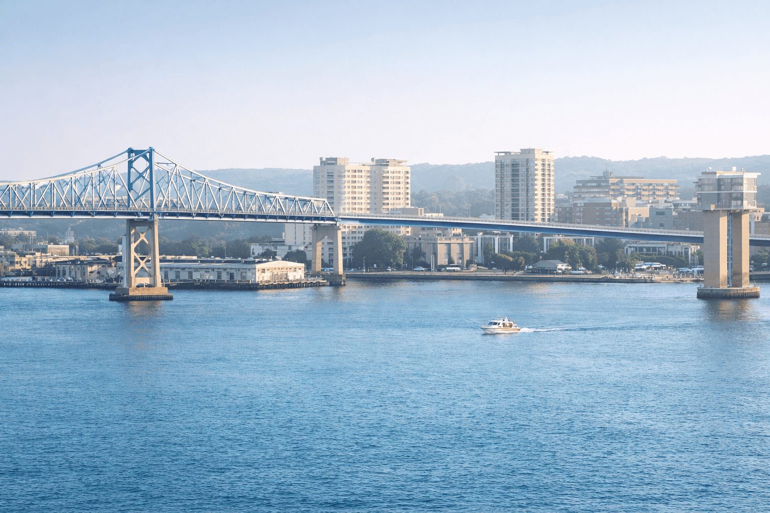 Bridge over a river with city skyline